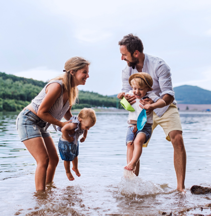 Family playing in a river.