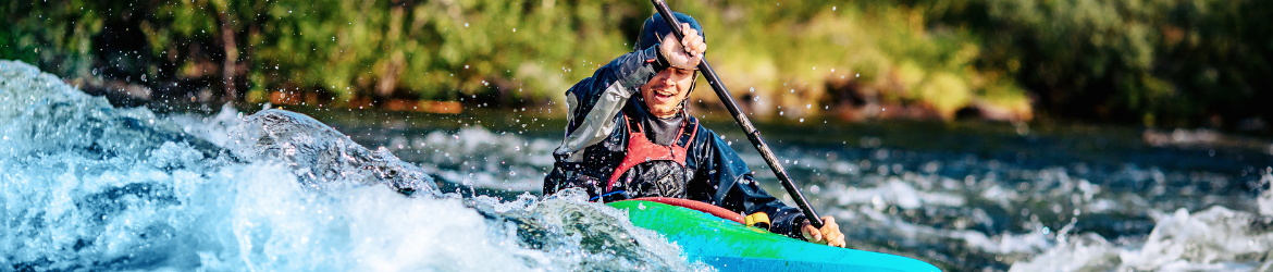 Man whitewater rafting.