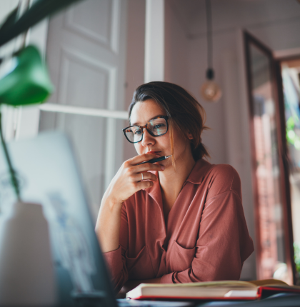 Woman sitting down and looking at computer.