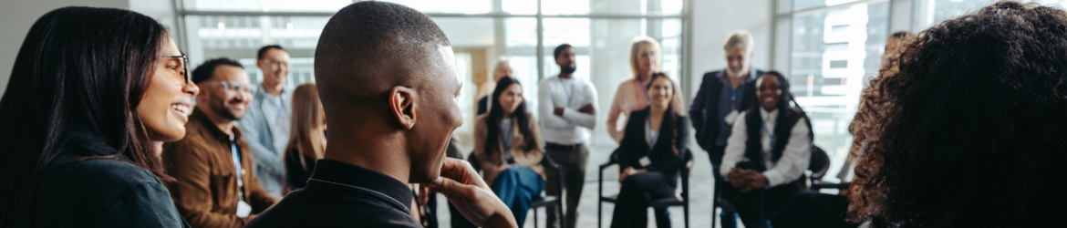 Group of people in a circle engaging in conversation.