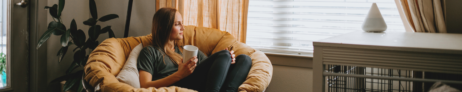 Woman relaxing in comfy living room chair