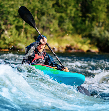 Man whitewater kayaking. 