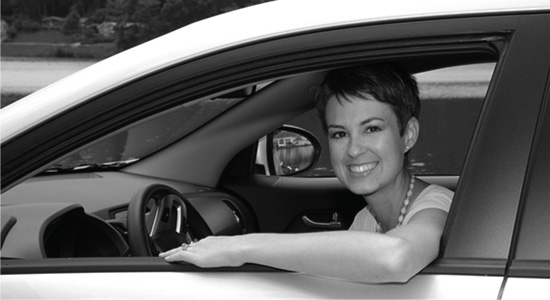 Woman leaning out of car window.