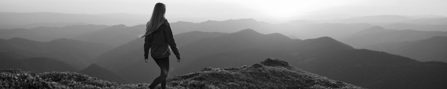 Woman walking on top of Blue Ridge Mountain overlook.