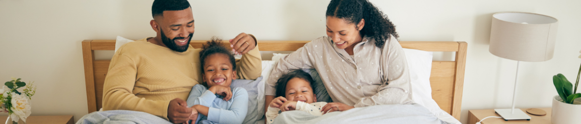 Happy family in bed.
