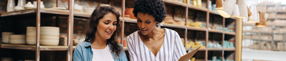 Two business women in pottery room. 