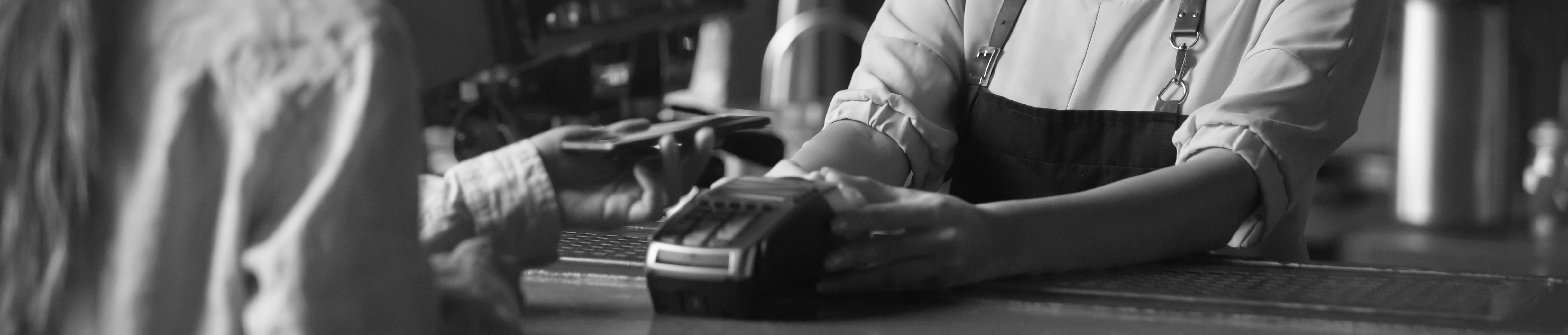 Woman using digital wallet on smartphone to complete contactless transaction through digital wallet