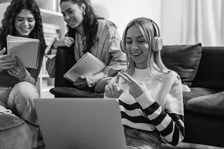 College-aged girls making lists and smiling.