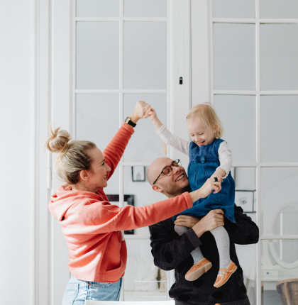Family dancing in the living room.