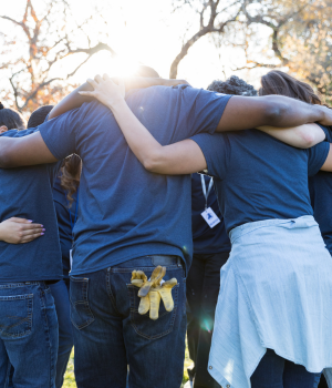 Group of volunteers huddle together.